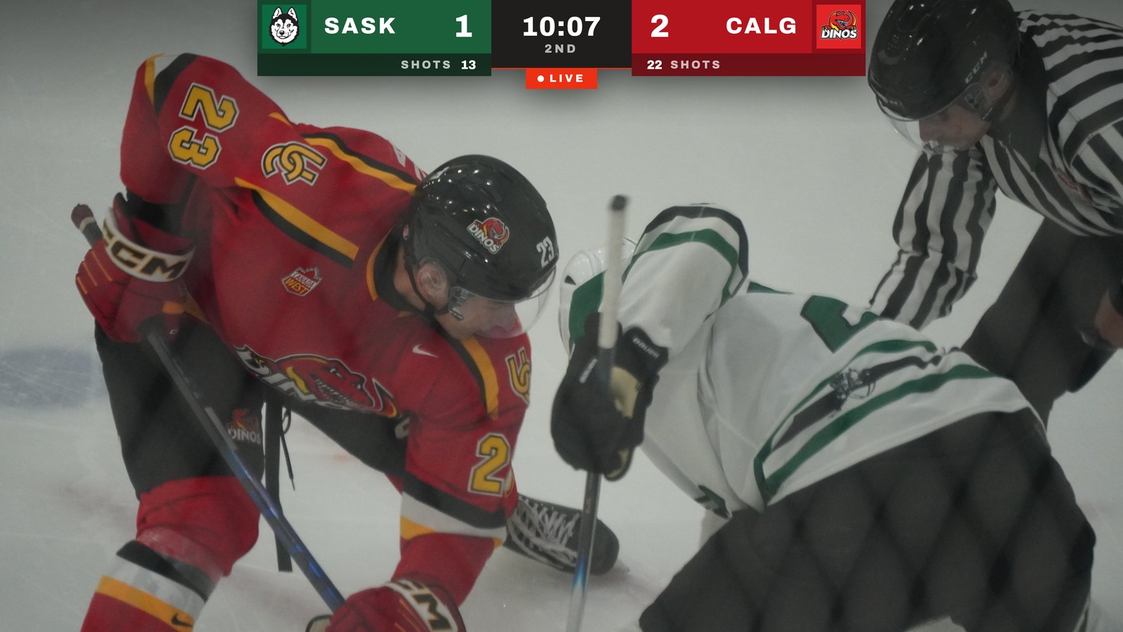 A frame from a Hockey Puck Media broadcast: Saskatchewan Huskies at Calgary Dinos, with team logos, score, shots on goal and the game clock on screen.